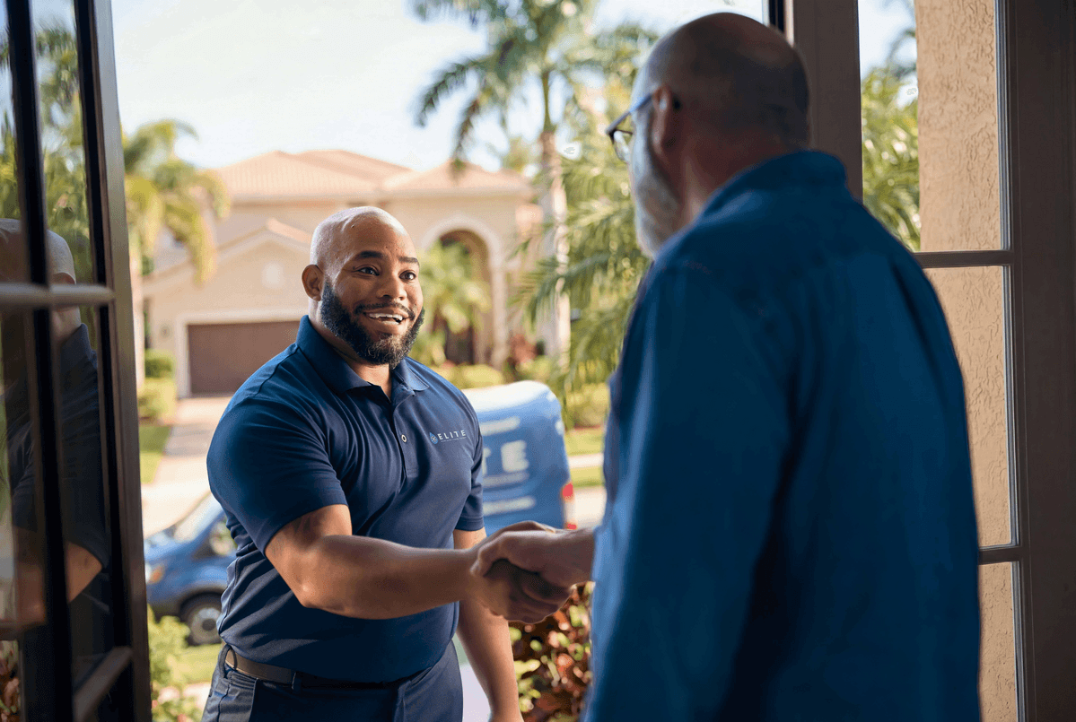 An Elite technician discusses the repair and installation services with a homeowner.