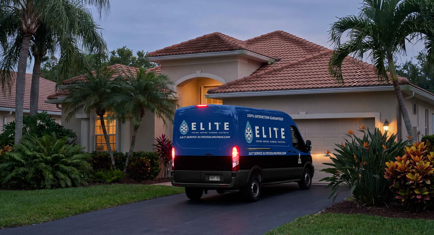 An Elite service van parked in a residential driveway at night, arriving to provide 24/7 emergency heating repair services.