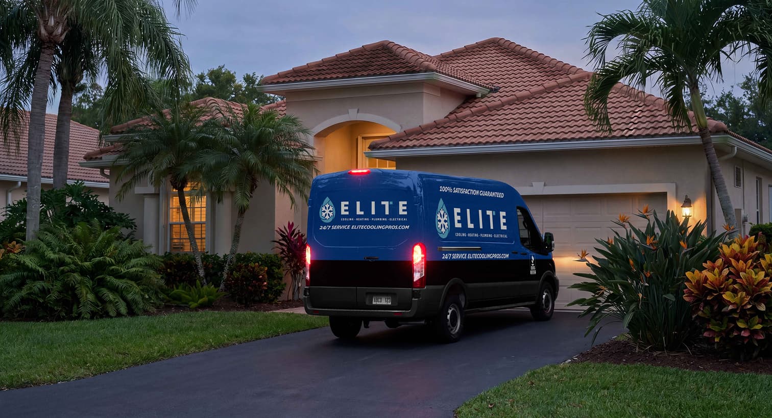An Elite service van parked in a residential driveway at dusk, arriving to provide 24/7 emergency AC repair services.