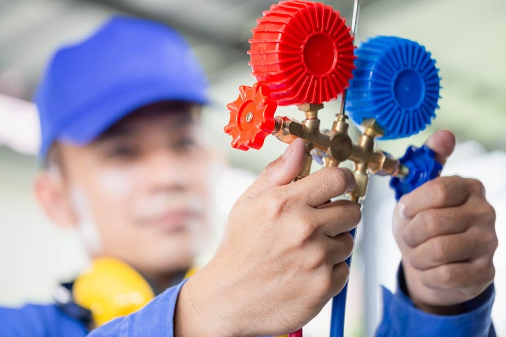 Technician Fixing AC Refrigerant Leak