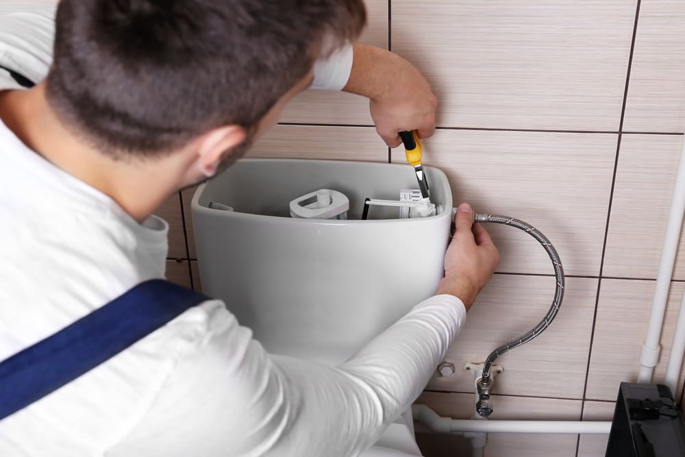 man performing a toilet repair service